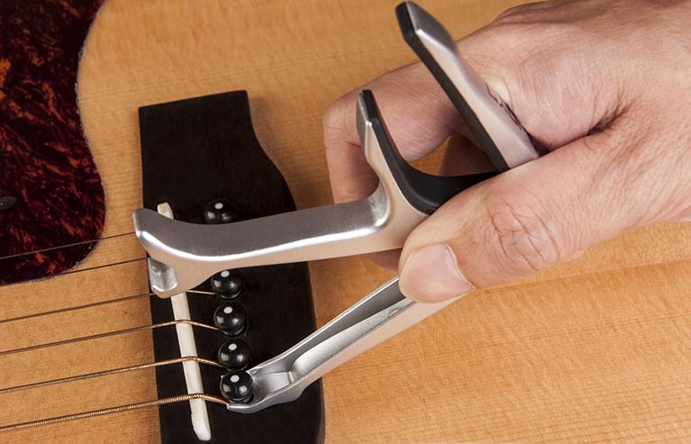 Joyo JCP-02 Multifunction Guitar Capo + Bottle Opener & Bridge Pin Puller - GuitarPusher